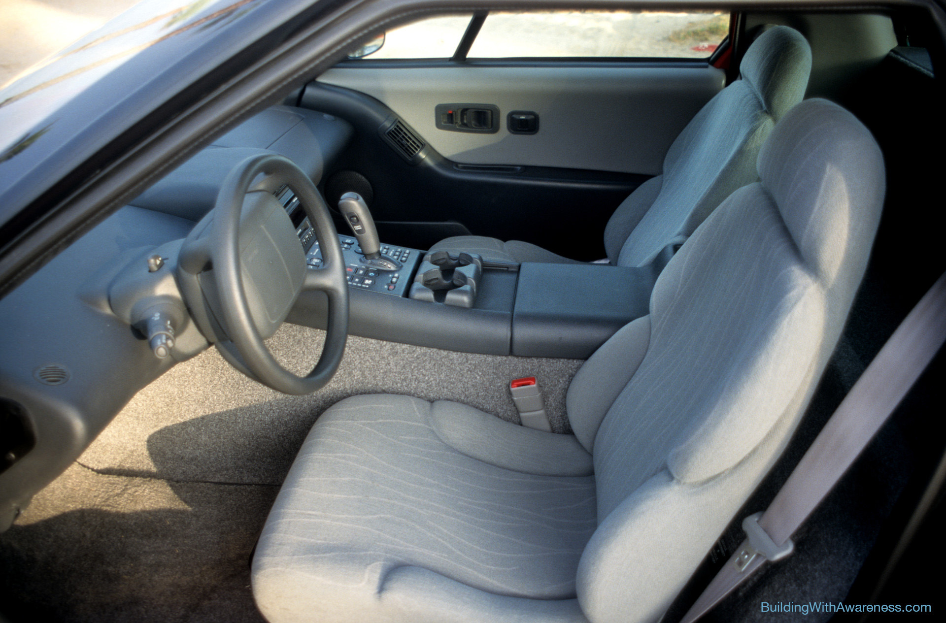EV1 electric car interior view showing the two seats and the center console.